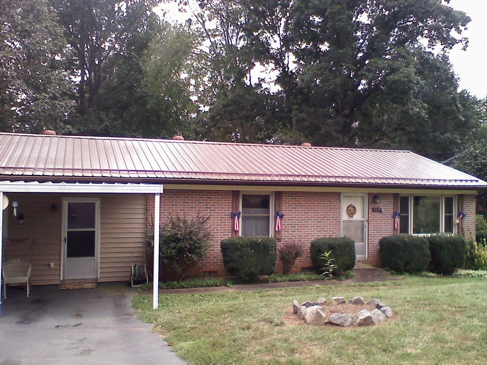 Bronze metal roof and carport on a brick ranch home — Roof Repair work by our crew in Darlington